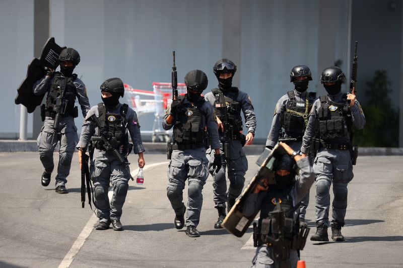 Thai security forces leave the Terminal 21 mall after completing their mission to stop a soldier on a rampage after a mass shooting, Nakhon Ratchasima