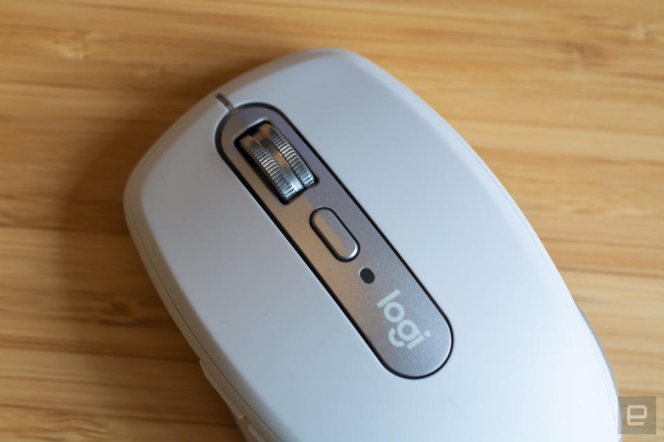 The Logitech MX Anywhere 3 mouse on a wooden table.