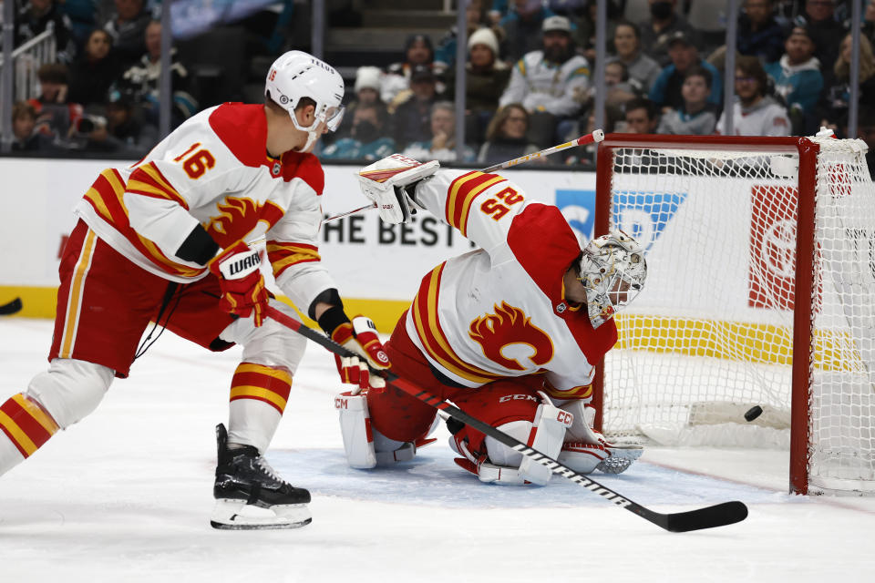 Calgary Flames defenseman Nikita Zadorov (16) and goaltender Jacob Markstrom (25) watch the puck as San Jose Sharks right wing Timo Meier (not shown) scores a power-play goal in the first period of an NHL hockey game Sunday, Dec. 18, 2022, in San Jose, Calif. (AP Photo/Josie Lepe)