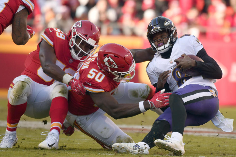 Kansas City Chiefs linebackers Justin Houston (50) and Reggie Ragland (59) sack Baltimore Ravens quarterback Lamar Jackson (8) during the second half of an NFL football game in Kansas City, Mo., Sunday, Dec. 9, 2018. (AP Photo/Ed Zurga)