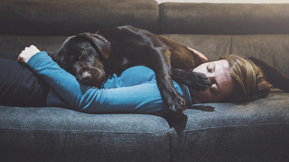 Dog sleeping on woman