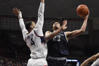 Georgetown's Collin Holloway (23) shoots as Connecticut's Tyrese Martin defends in the first half of an NCAA college basketball game, Tuesday, Jan. 25, 2022, in Storrs, Conn. (AP Photo/Jessica Hill)