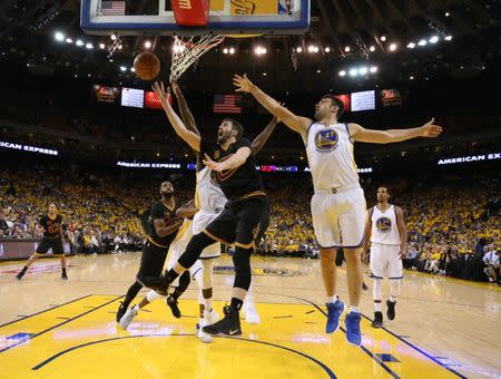 Jun 4, 2017; Oakland, CA, USA; Cleveland Cavaliers forward Kevin Love (0) shoots against Golden State Warriors center Zaza Pachulia (27) during the second half in game two of the 2017 NBA Finals at Oracle Arena. Mandatory Credit: Ezra Shaw/Pool Photo via USA TODAY Sports