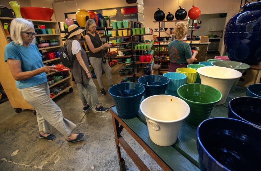 LOS ANGELES, CA-AUGUST 11, 2023: Eulalia Halloran, left, of Pasadena, shops with other customers inside Bauer Pottery in Los Angeles. The shop, which has an almost cult like following, recently lost its lease. (Mel Melcon / Los Angeles Times)