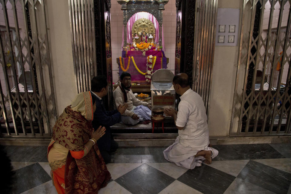 In this Tuesday, Jan. 1, 2019 photo, Hindu devotees pray at the Dhakeshwari Temple in Dhaka, Bangladesh. While Sheikh Hasina is set to begin her third consecutive term as Bangladesh's prime minister following a landslide election victory, critics say having such an overwhelming majority in parliament could create space for her to become even more authoritarian. Still, Hasina enjoys a lot of support, especially from religious minorities in the Muslim-majority nation who say she has safeguarded their rights. At the Dhakeshwari Temple in Dhaka, Hindus poured in on Tuesday to pray and get a glimpse of the Goddess Durga, something they say was not possible under previous governments. (AP Photo/Anupam Nath)