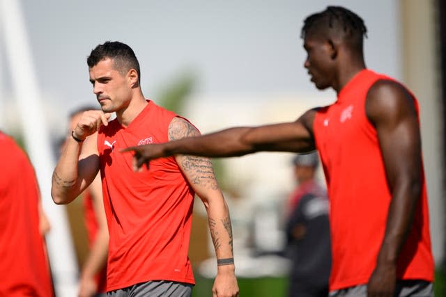 Switzerland midfielder Granit Xhaka, left, is not planning to follow Germany's lead