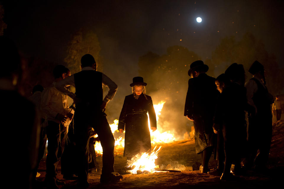 <p>Ultra-Orthodox Jews stand next to bonfires during Lag Ba’Omer celebrations in Bnei Brak, Israel, on May 13, 2017. Lag Ba’Omer commemorates the end of a plague said to have decimated Jews in Roman times. (Photo: Oded Balilty/AP) </p>