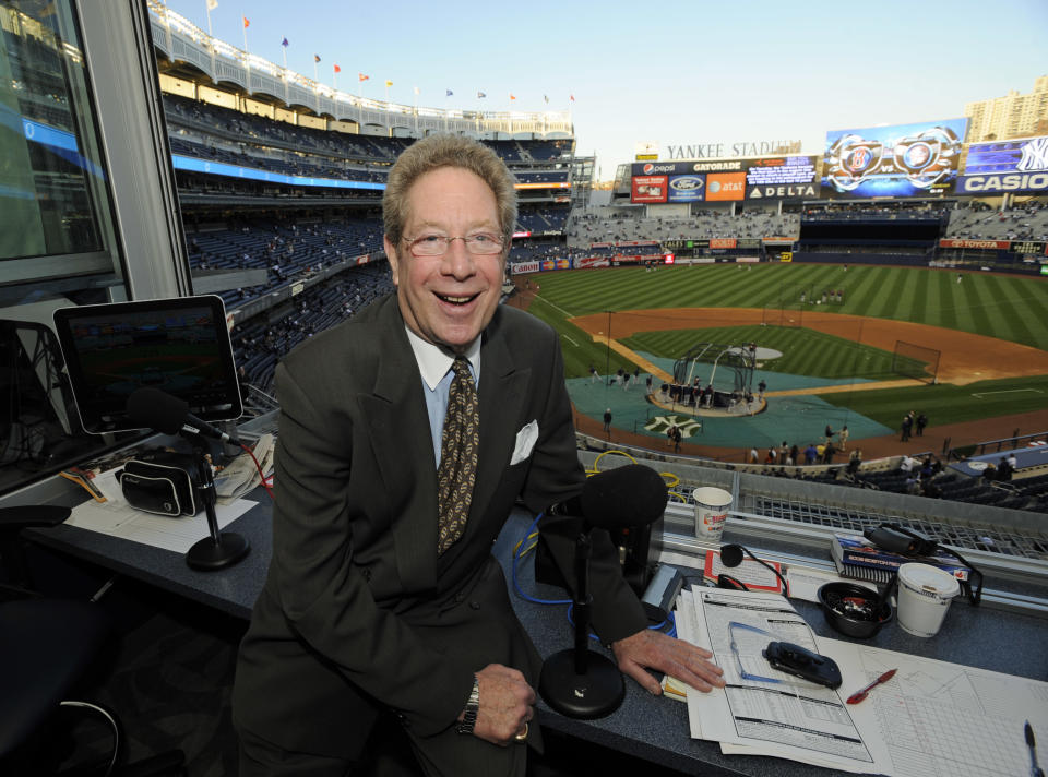 In this photo taken on Friday, Sept. 25, 2009, New York Yankees broadcaster John Sterling sits his booth before a baseball game against the Boston Red Sox at Yankee Stadium in New York. Sterling has been the distinctive voice of the Yankees for 20 years, the heir to one of the most coveted and influential seats in sports radio.(AP Photo/Bill Kostroun)
