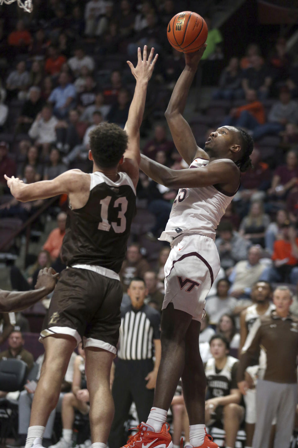 Virginia Tech's Justyn Mutts (25) shoots while guarded by Lehigh's Keith Higgins Jr.(13) during the first half of an NCAA college basketball game Thursday, Nov. 10, 2022, in Blacksburg, Va. (Matt Gentry/The Roanoke Times via AP)