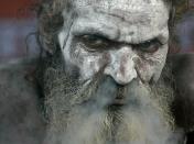 A Nanga Sadhu, or naked Hindu holy man with his face smeared with holy ash exhales smoke after puffing marijuana at a transit camp on the way to Gangasagar, in Calcutta, India, Saturday, Jan. 9, 2010. Pilgrims started pour into the city to take a holy dip at the confluence of River Ganges and Bay of Bengal at Sagar Island, about 140 kilometers (87 miles) south of Calcutta, on the auspicious day of Makarsankranti on Jan. 14. (AP Photo/Bikas Das)