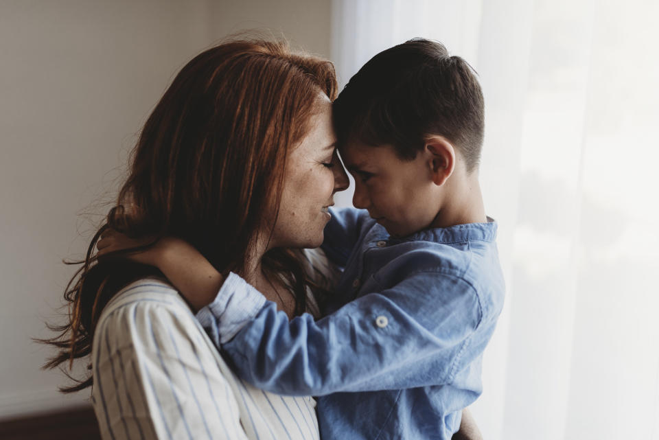 A mother hugging her son