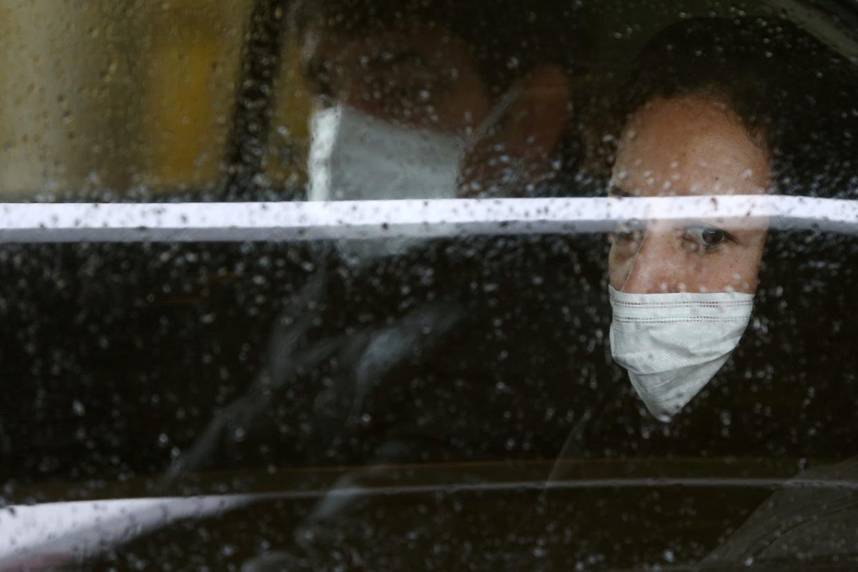 Iranian people wear protective masks to prevent contracting coronavirus, as they sit in taxi in Tehran, Iran February 25, 2020.WANA (West Asia News Agency)/Nazanin Tabatabaee via REUTERS