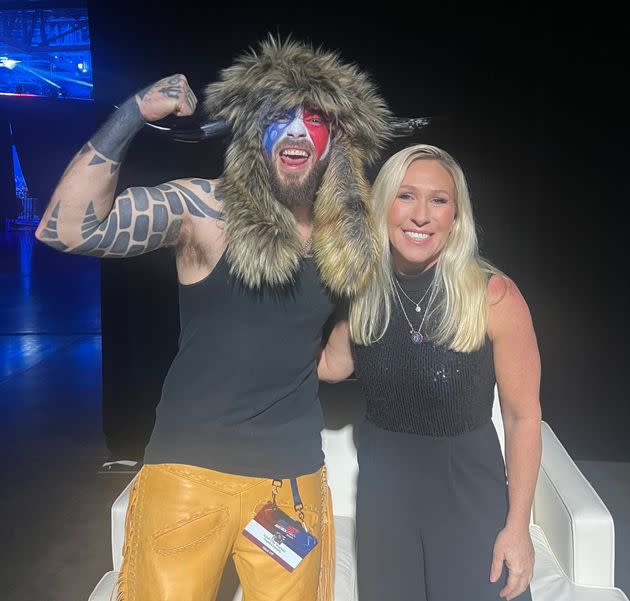 Rep. Marjorie Taylor Greene (R-Ga.), right, recently met with so-called QAnon Shaman Jacob Chansley, lamenting that the prominent Capitol riot participant had been treated 