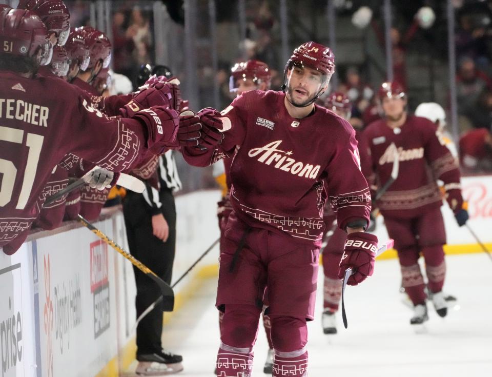 Arizona Coyotes defenseman Shayne Gostisbehere (14) is congratulated on his short-handed goal against the Nashville Predators during the first period at Mullett Arena in Tempe on Feb. 26, 2023.