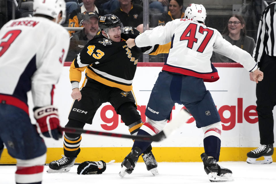 Pittsburgh Penguins' Jansen Harkins (43) and Washington Capitals' Beck Malenstyn (47) fight during the second period of an NHL hockey game in Pittsburgh, Thursday, March 7, 2024. (AP Photo/Gene J. Puskar)