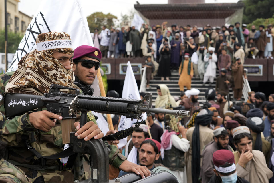 Taliban fighters celebrate one year since they seized the Afghan capital, Kabul, in front of the U.S. Embassy in Kabul, Afghanistan, Monday, Aug. 15, 2022. The Taliban marked the first-year anniversary of their takeover after the country's western-backed government fled and the Afghan military crumbled in the face of the insurgents' advance. (AP Photo/Ebrahim Noroozi)