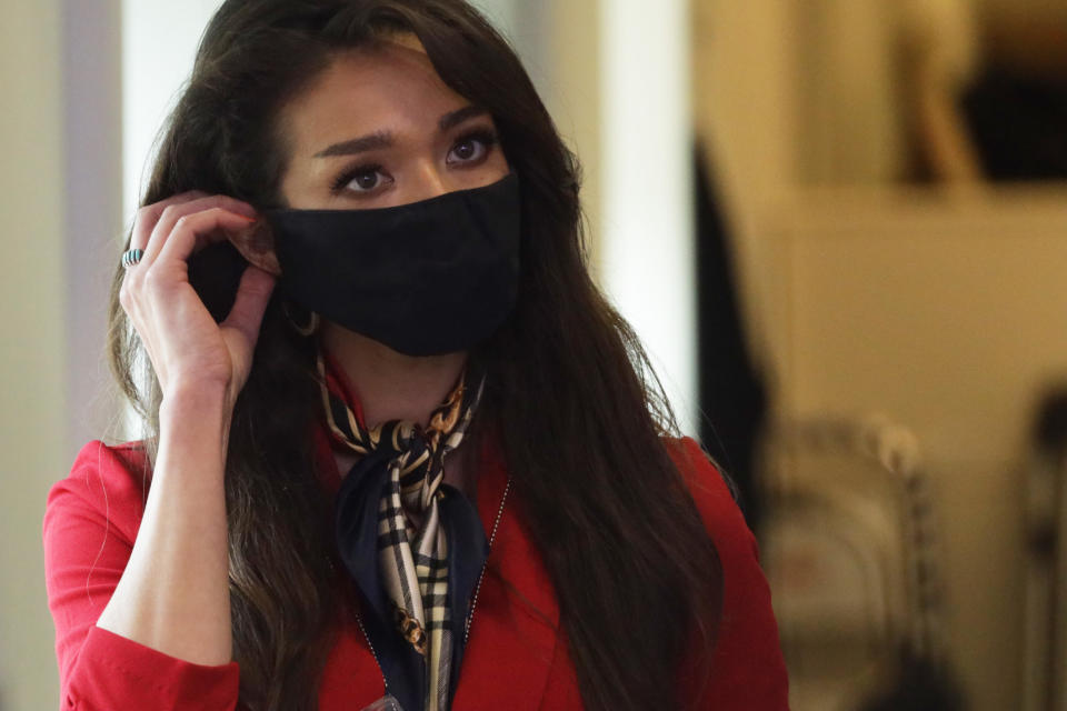 WASHINGTON, DC - MAY 22:  Chanel Rion of One America News Network (OAN) put her mask back on after she asked a question during a news briefing at the James Brady Press Briefing Room of the White House on May 22, 2020 in Washington, DC. President Trump announced news CDC guidelines that churches and places of worship are essential and must reopen now. (Photo by Alex Wong/Getty Images)