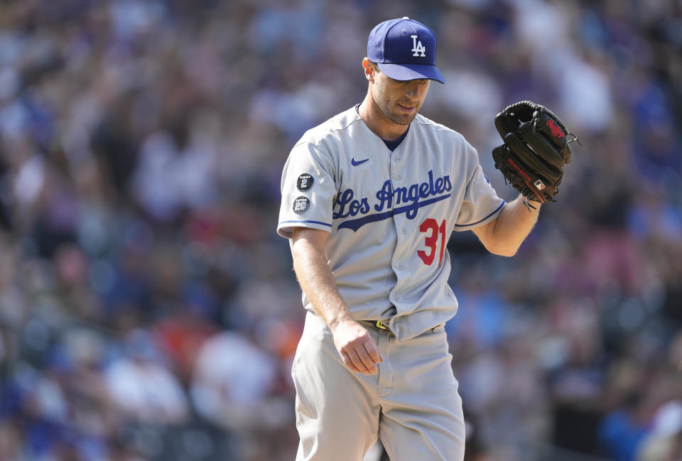 Los Angeles Dodgers starting pitcher Max Scherzer reacts after giving up a two-run home run to Colorado Rockies' Raimel Tapia in the fifth inning of a baseball game Thursday, Sept. 23, 2021, in Denver. (AP Photo/David Zalubowski)