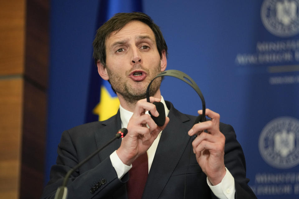 Dutch Foreign Minister Wopke Hoekstra holds his headphones during joint press statements with French Foreign Minister Catherine Colonna and Romanian Foreign Minister Bogdan Aurescu in Bucharest, Romania, Friday, Jan. 27, 2023. (AP Photo/Andreea Alexandru)