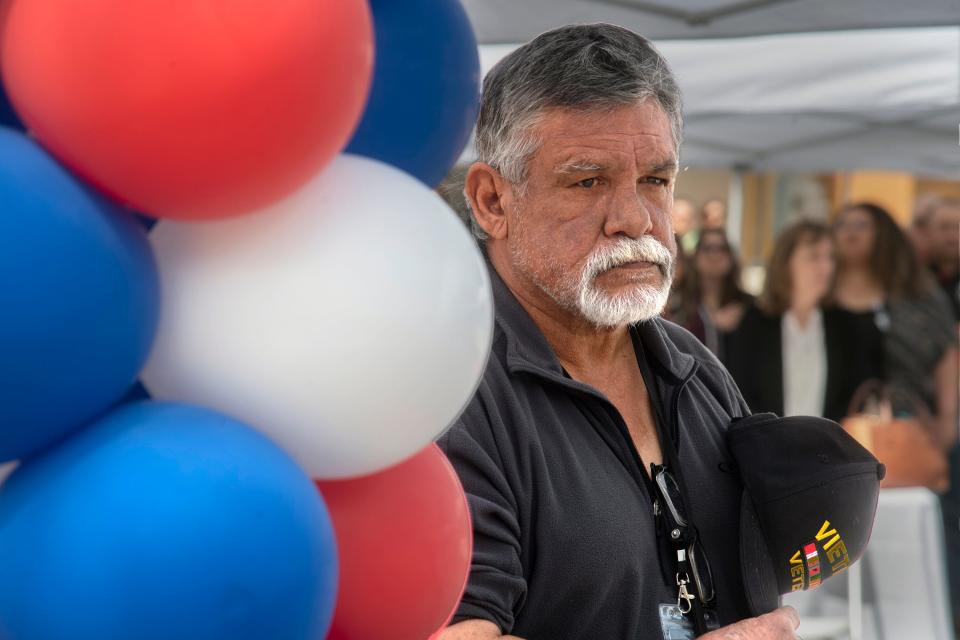 Resident and Vietnam veteran Bruno Stoll stands for the national anthem during the grand opening ceremony for the Liberty Square low income housing in downtown Stockton. 