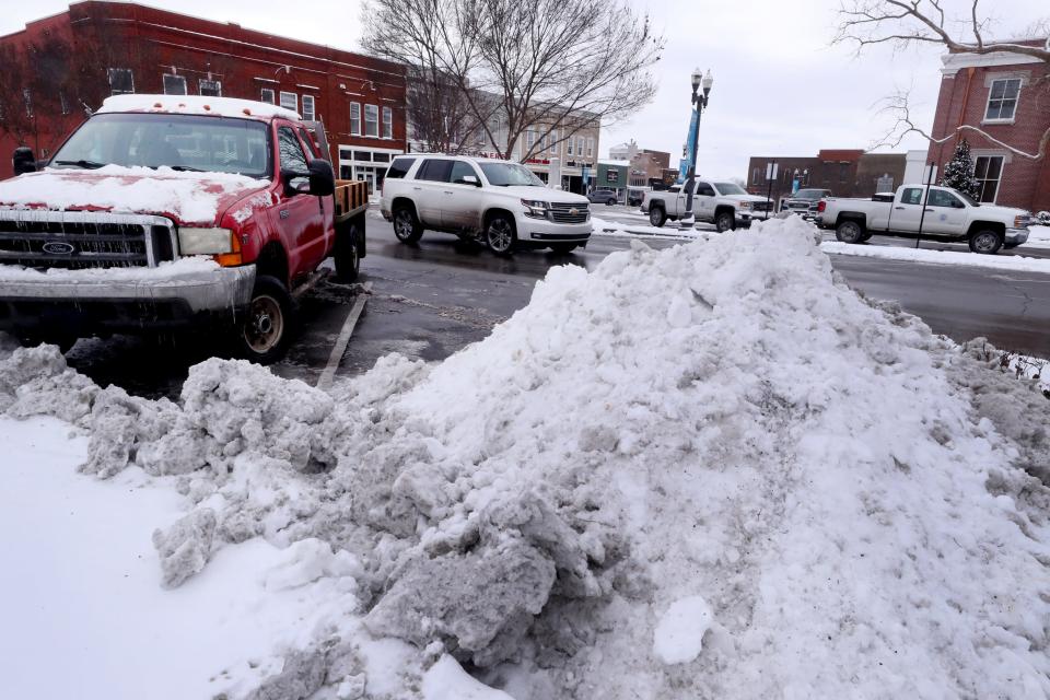 Snow that was removed from the roads and parking spaces in downtown Murfreesboro can be seen piled in areas around the square on Tuesday, Jan. 16, 2024.