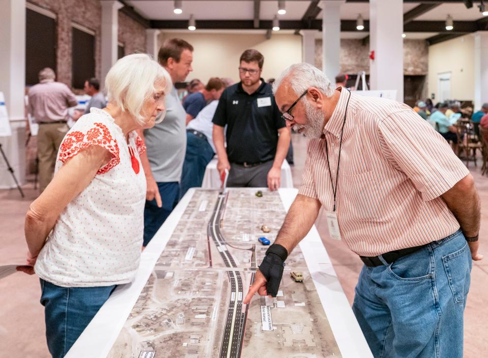 Linda Ruff, left, listens as Indiana Department of Transportation’s Kahlil Dughaish explains how to navigate the changes to the Lloyd Expressway during a public hearing Tuesday, Sept. 26, 2023.