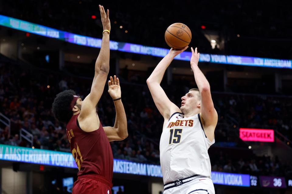 Denver Nuggets center Nikola Jokic (15) shoots against Cleveland Cavaliers center Jarrett Allen (31) during the second half of an NBA basketball game, Thursday, Feb. 23, 2023, in Cleveland. (AP Photo/Ron Schwane)