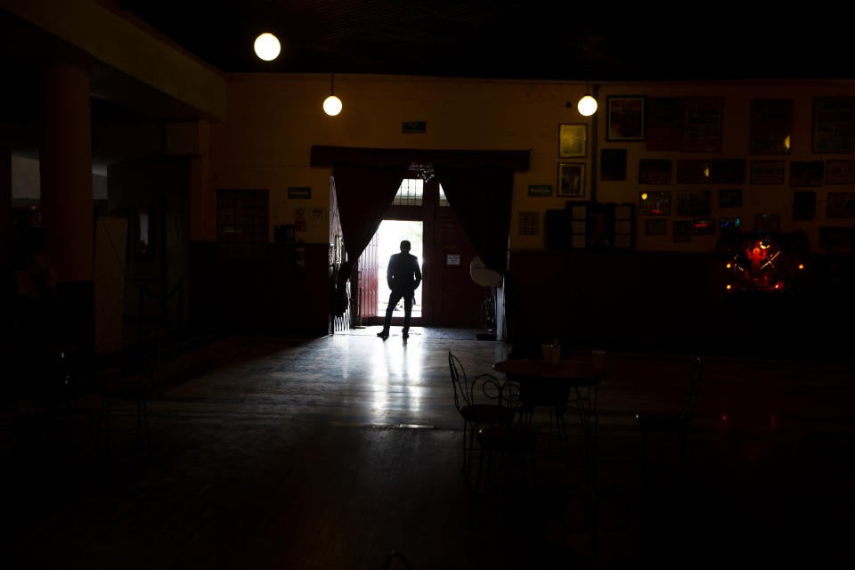 Miguel Nieto, the owner of Salon Los Angeles, waits at the entrance for people to attend an event to raise money and keep open the iconic dance hall known as “The Cathedral of Mambo” amid the new coronavirus pandemic in Mexico City, Saturday, Sept. 5, 2020. Millionaires, writers, ambassadors, and movie stars danced here; now, shuttered for more than five months due to the pandemic, the owners of the fabled hall say they are in debt and may have to close and demolish it. (AP Photo/Fernando Llano)