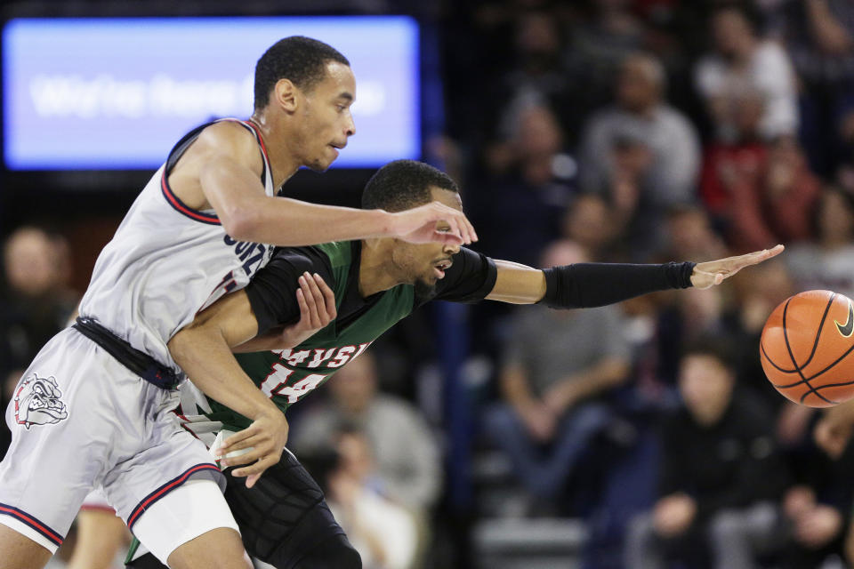 Gonzaga guard Nolan Hickman, left, and Mississippi Valley State guard George Ivory III, right, go after the ball during the first half of an NCAA college basketball game, Monday, Dec. 11, 2023, in Spokane, Wash. (AP Photo/Young Kwak)