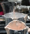 Heated raw material for filling molds streams from a pipe at the Doc Johnson sex toy factory in Los Angeles, California