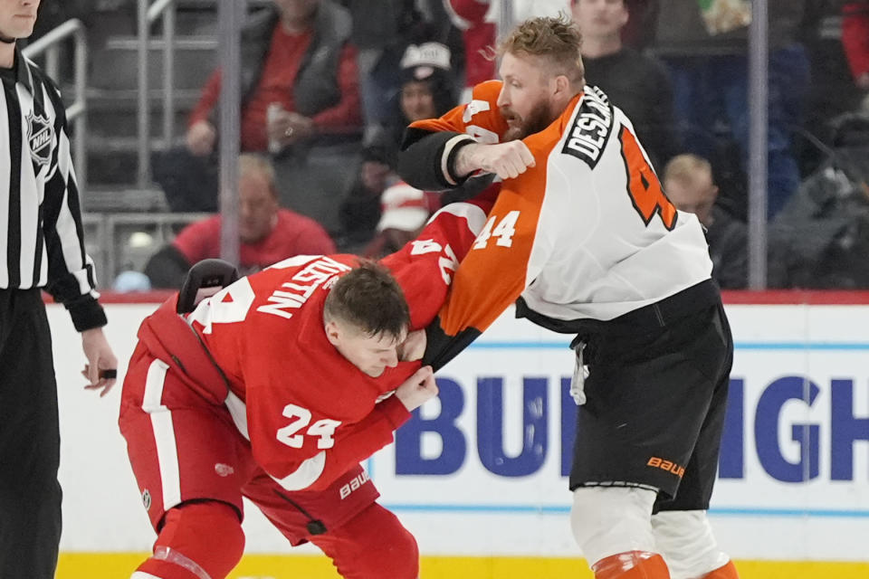 Detroit Red Wings center Klim Kostin (24) and Philadelphia Flyers left wing Nicolas Deslauriers (44) fight during the second period of an NHL hockey game, Thursday, Jan. 25, 2024, in Detroit. (AP Photo/Carlos Osorio)