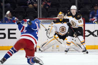 Boston Bruins goaltender Kyle Keyser (85) and defenseman Urho Vaakanainen (58) block the goal as New York Rangers left wing Artemi Panarin shoots during the third period of a preseason NHL hockey game, Tuesday, Sept. 28, 2021, at Madison Square Garden in New York. (AP Photo/Corey Sipkin).