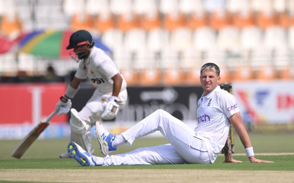 Brydon Carse on the ground after bowling