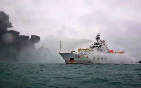 The Chinese firefighting vessel Donghaijiu 117 sprays water on the burning tanker Sanchi - Credit: Handout via AFP