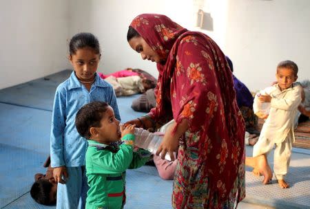 A boy drinks water inside a relief camp after his family evacuated their village near the border with Pakistan in Ranbir Singh Pora, southwest of Jammu, September 30, 2016. REUTERS/Mukesh Gupta