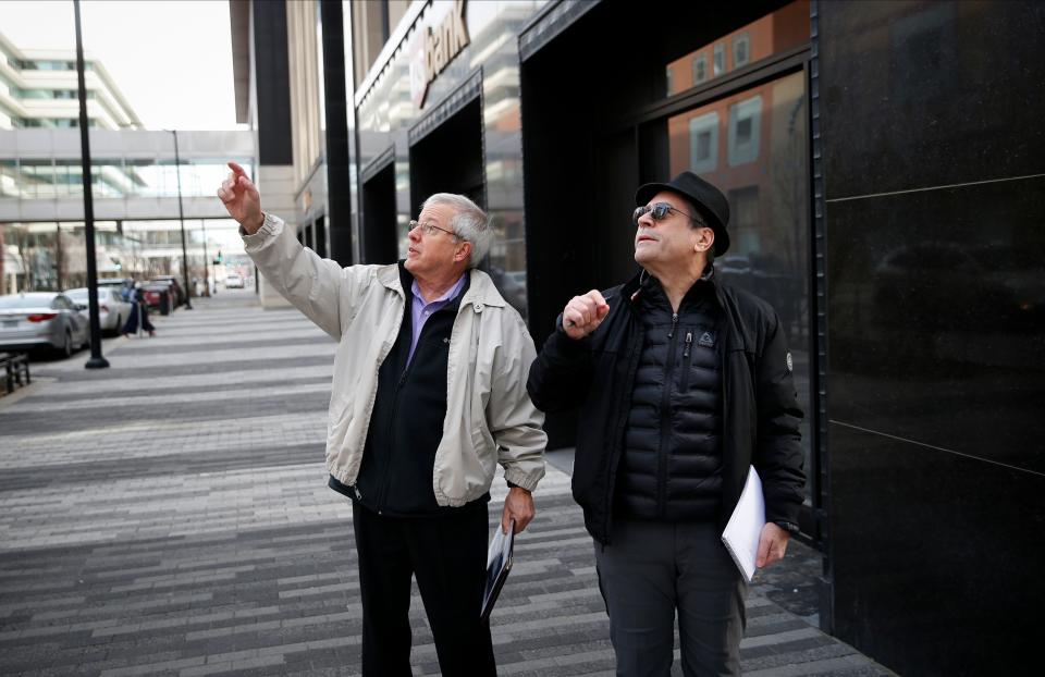 Retired architect Steve Stimmel, left, an architectural historian, points out details of a Proudfoot & Bird-designed building to the Des Moines Register's Bill Steiden during a downtown tour.