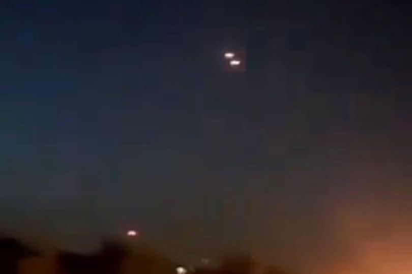 Screenshots from videos taken of the airstrike show missiles entering Iran, lighting up the night sky as fires already burn at hit facilities