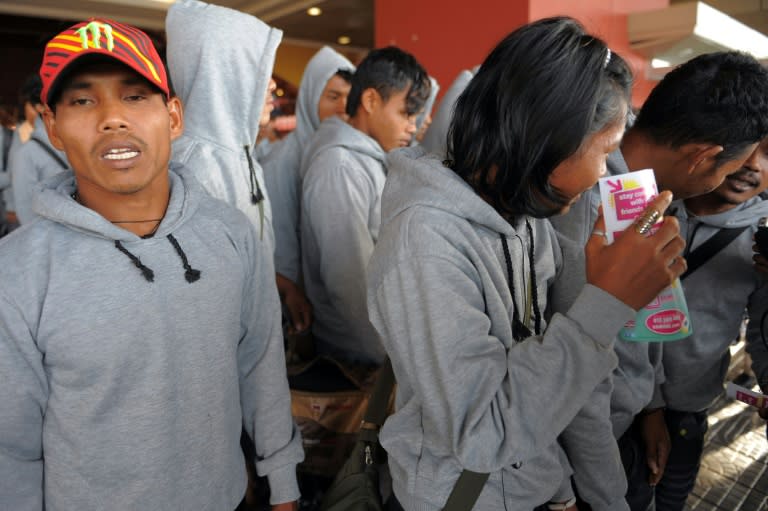 Cambodian trafficked fishermen returned from Indonesia after being freed or escaping from slave-like conditions on Thai fishing vessels, talk to journalists at the Phnom Penh International airport on December 12, 2011
