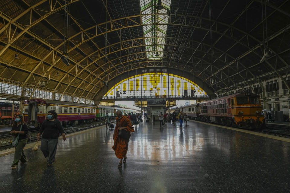 Passengers walks along the platform at the Hua Lamphong railway station in Bangkok, Thailand, Wednesday, Jan. 18, 2023. As Thailand officially opened what is said to be Southeast Asia's largest train station in Bangkok, Thursday, Jan. 19, 2023, the century-old iconic station will still be used for local operations for the time being. (AP Photo/Sakchai Lalit)