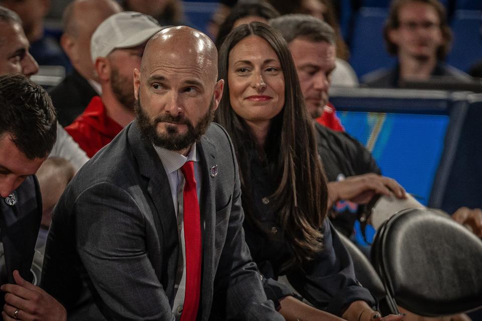 John Jakus sits with his wife, Sara, at Friday's news conference where he was introduced as FAU's new head men's basketball coach at the Eleanor R. Baldwin Arena on campus in Boca Raton.