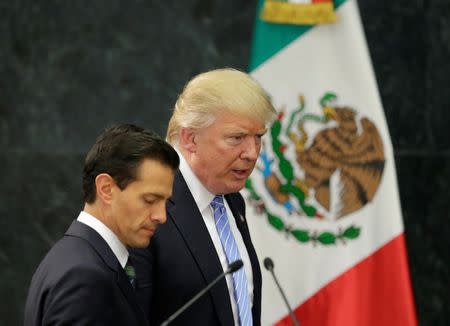 Donald Trump and Mexico's President Enrique Pena Nieto arrive for a press conference at the Los Pinos residence in Mexico City. REUTERS/Henry Romero