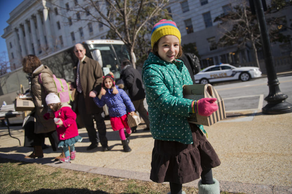 Naomi Sherman, 4, right, along with her father, Rep. Brad Sherman (D-Calif.); mother, Lisa; and sisters, Lucy, 2, and Molly, 5, prepares to board a bus that will take House Democrats and their families to a retreat in Philadelphia on Jan. 28, 2015.