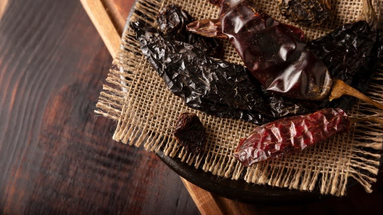 dried peppers on woven mat