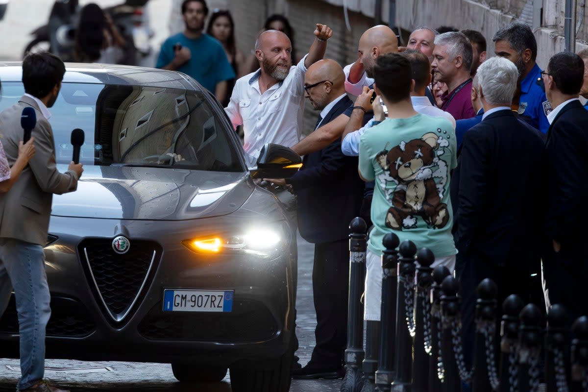 Gennaro Sangiuliano (C) leaves the ministry, in Rome, Italy, on Friday after tendering his resignation (EPA)