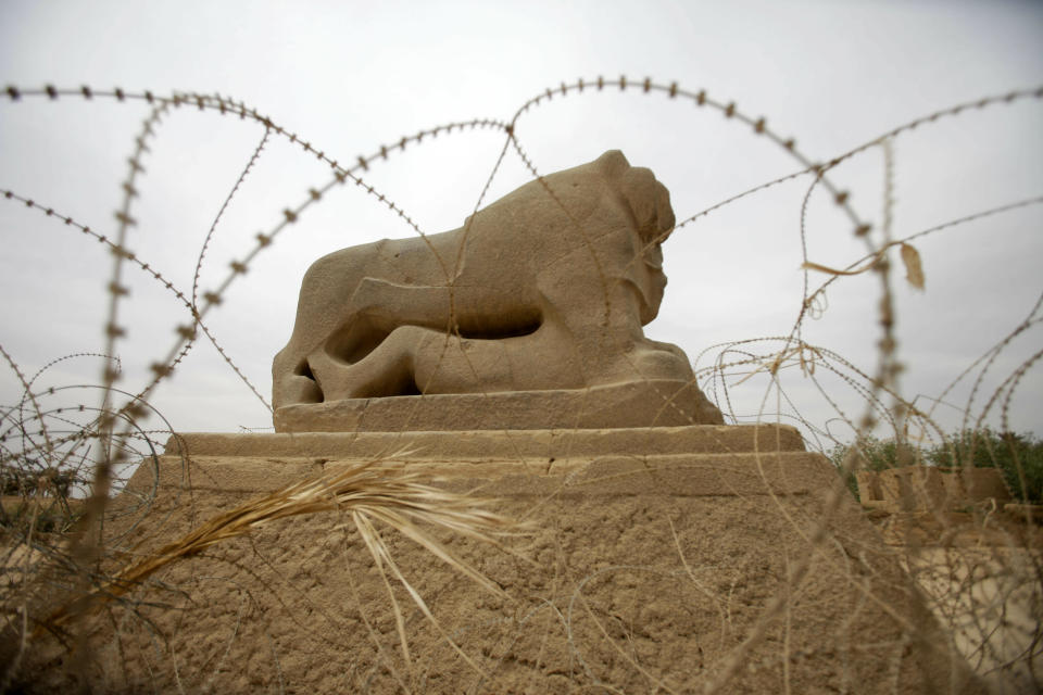 FILE - In this Sunday, May 6, 2012 file photo, barbed wire surrounds the Lion of Babylon at the archaeological site of Babylon. Iraq. Iraq is celebrating UNESCO's World Heritage Committee's naming the historic city of Babylon a World Heritage Site in a vote in Azerbaijan. Friday, July 5, 2019 vote comes after Iraq bid for years for Babylon to become a World Heritage Site. (AP Photo/Khalid Mohammed, File)