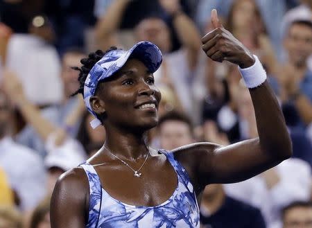 Venus Williams of the U.S celebrates with a thumbs-up to the crowd after defeating Timea Bacsinszky of Switzerland following their women's singles match at the U.S. Open tennis tournament in New York August 27, 2014. REUTERS/Shannon Stapleton