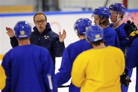 Sweden's head coach Par Marts (2nd L) talks to his team during a men's ice hockey practice at the 2014 Sochi Winter Olympics February 20, 2014. REUTERS/Brian Snyder