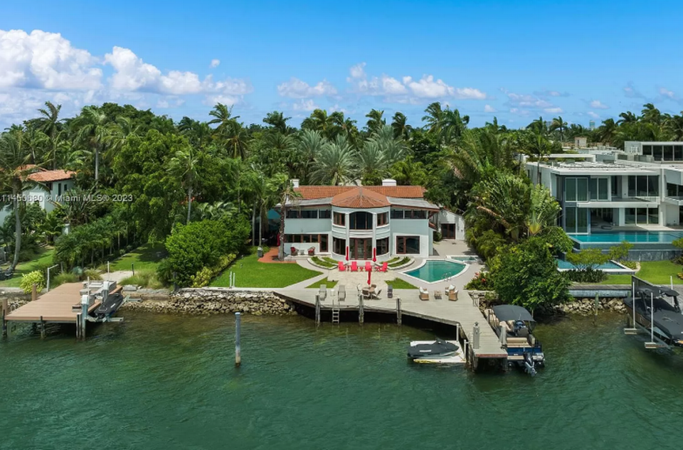 Sitting on a 0.42-acre lot, the Hibiscus Island residence has a 101 feet of water frontage, boat dock, and pool.