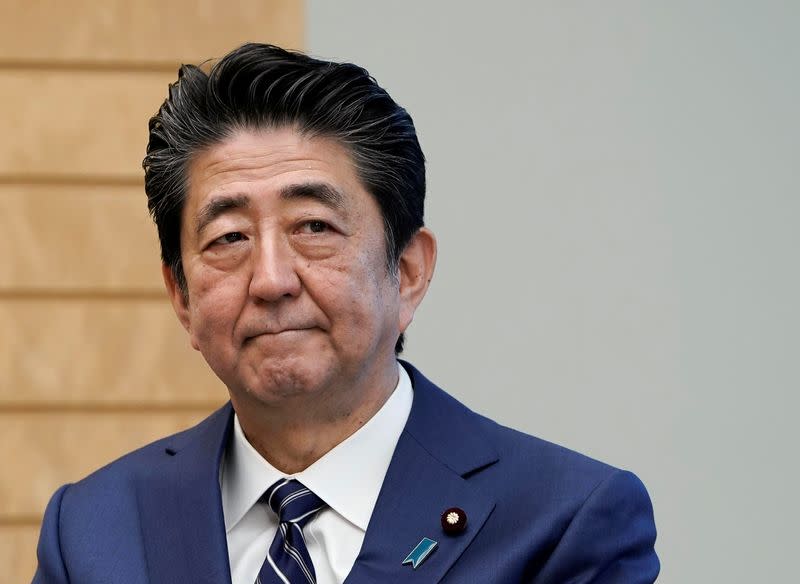 Japanese Prime Minister Shinzo Abe listens to IAEA Director General Rafael Grossi at the prime minister's official residence in Tokyo
