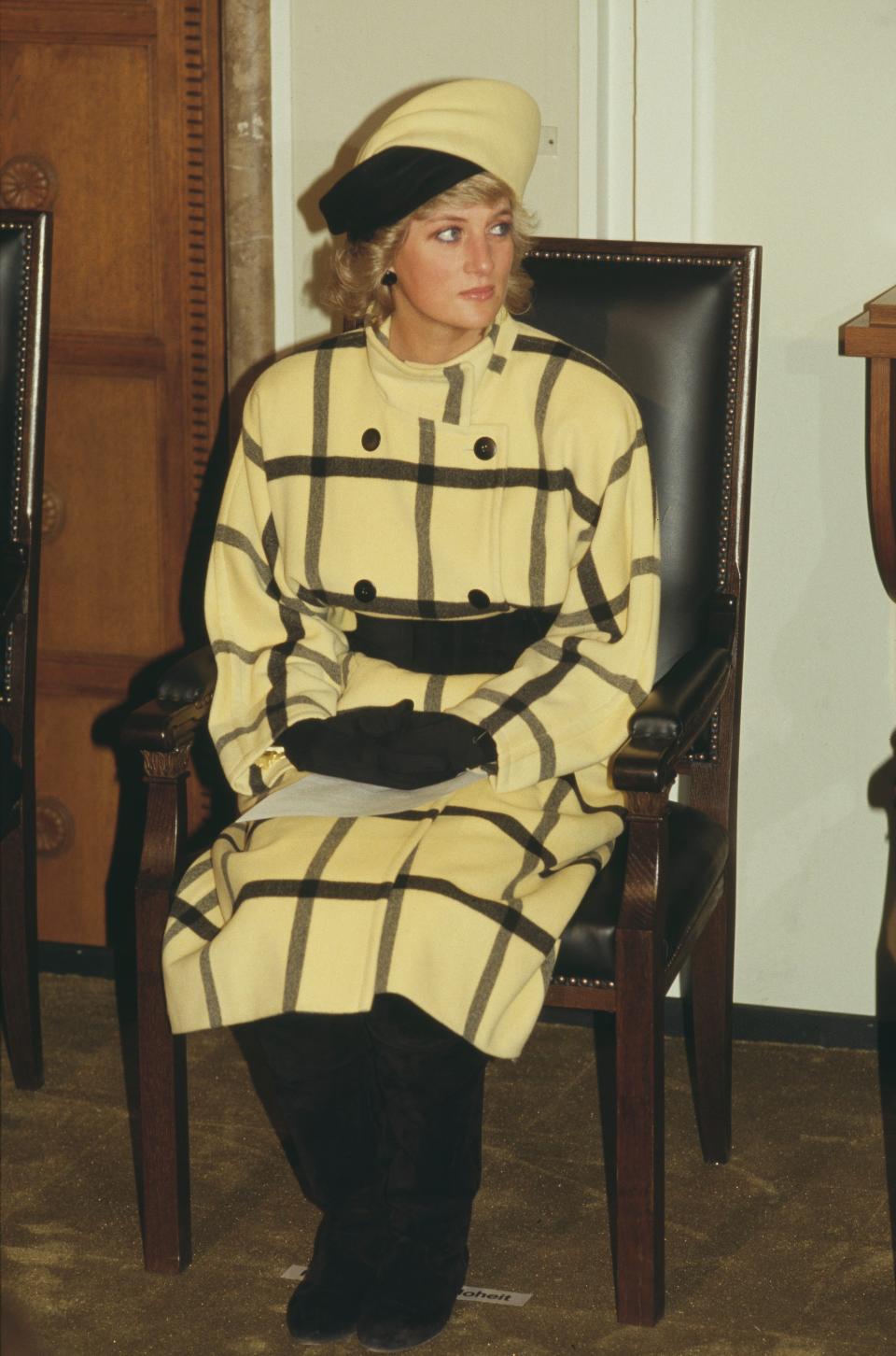 Princess Diana wears a yellow coat in November 1987.